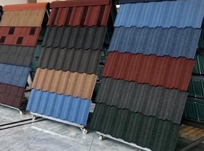 Various multicolored roofing tiles displayed upright on metal stands
